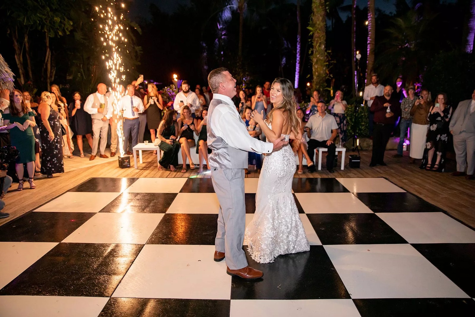Couple dancing energetically on a wood dance floor at an outdoor tented St. Louis reception