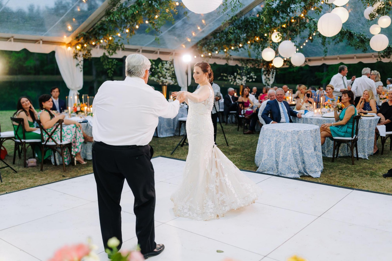 All white dance floor set up at an outdoor garden wedding reception near St. Louis